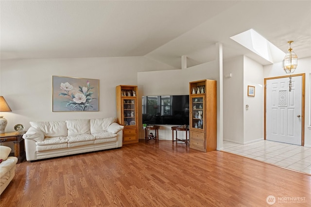 695 S Lyle Ave, East Wenatchee, WA 98802 - living area featuring a skylight, vaulted ceiling, and wood finished floors