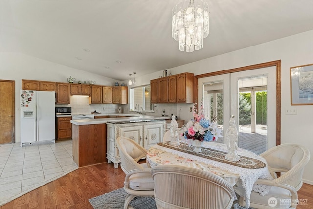 695 S Lyle Ave, East Wenatchee, WA 98802 - dining area featuring lofted ceiling, a chandelier, light wood-style floors, and french doors