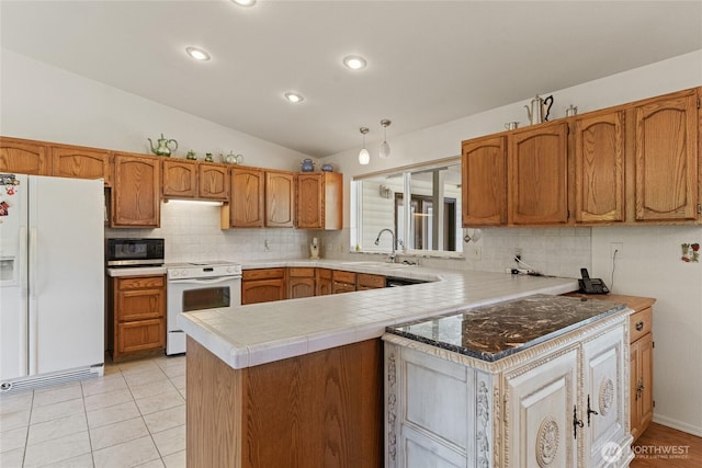 695 S Lyle Ave, East Wenatchee, WA 98802 - kitchen with white appliances, decorative backsplash, lofted ceiling, a peninsula, and brown cabinets