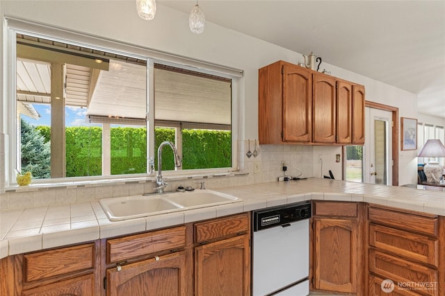 695 S Lyle Ave, East Wenatchee, WA 98802 - kitchen with white dishwasher, brown cabinets, a peninsula, and tasteful backsplash