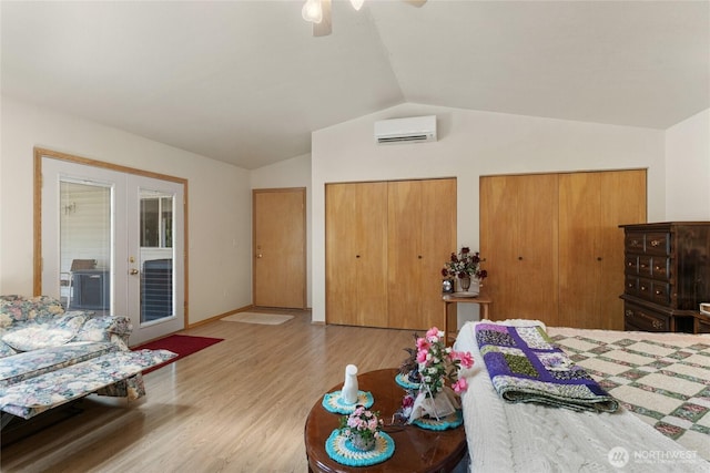695 S Lyle Ave, East Wenatchee, WA 98802 - bedroom featuring a wall mounted AC, french doors, lofted ceiling, two closets, and wood finished floors
