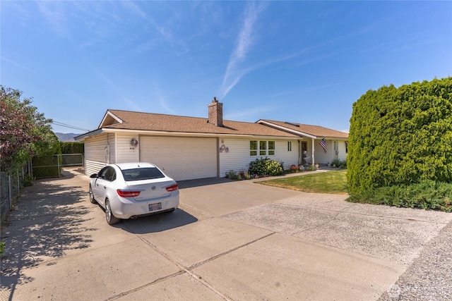 695 S Lyle Ave, East Wenatchee, WA 98802 - ranch-style home with concrete driveway, an attached garage, and a chimney