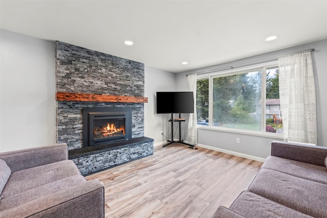 2202 28th Ave SE, Puyallup, WA 98374 - living room with a stone fireplace, wood finished floors, baseboards, and recessed lighting