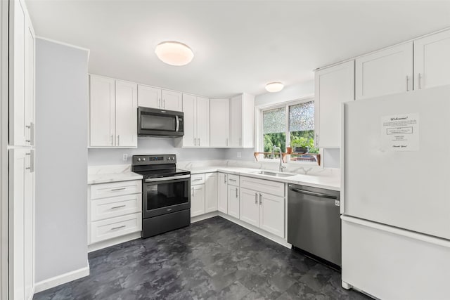 2202 28th Ave SE, Puyallup, WA 98374 - kitchen with appliances with stainless steel finishes, a sink, white cabinetry, light stone counters, and baseboards