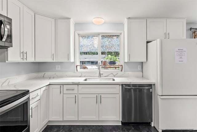 2202 28th Ave SE, Puyallup, WA 98374 - kitchen with stainless steel appliances, a sink, and white cabinetry