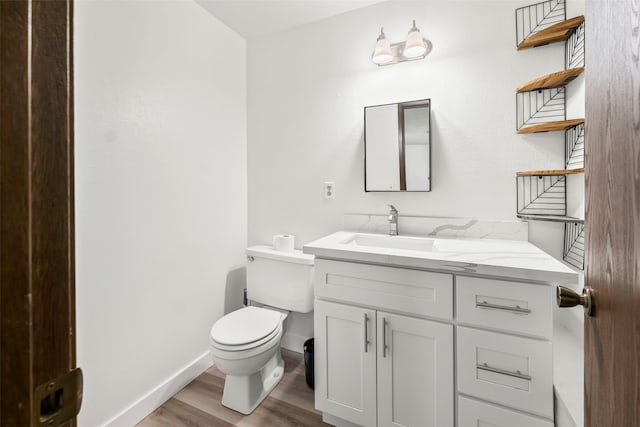2202 28th Ave SE, Puyallup, WA 98374 - half bathroom featuring toilet, wood finished floors, vanity, and baseboards