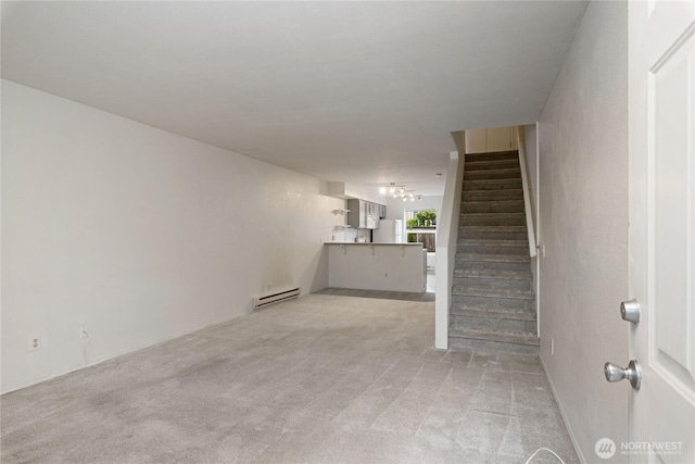 9817 132nd Street Ct E Unit B, Puyallup, WA 98373 - unfurnished living room featuring a baseboard radiator, stairs, and light colored carpet