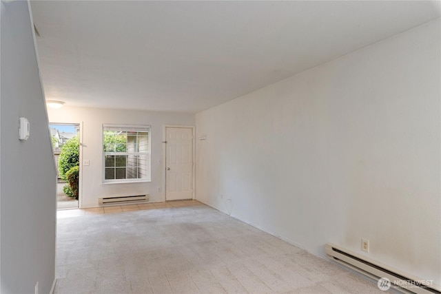 9817 132nd Street Ct E Unit B, Puyallup, WA 98373 - spare room featuring a baseboard heating unit and carpet floors