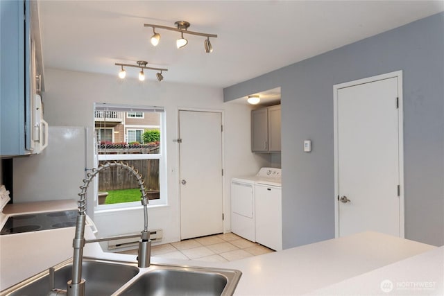 9817 132nd Street Ct E Unit B, Puyallup, WA 98373 - kitchen with separate washer and dryer, a sink, freestanding refrigerator, and light countertops