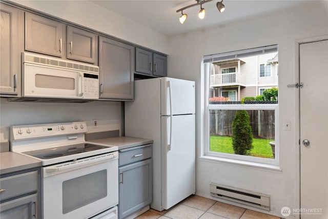 9817 132nd Street Ct E Unit B, Puyallup, WA 98373 - kitchen featuring white appliances, gray cabinets, baseboard heating, and plenty of natural light