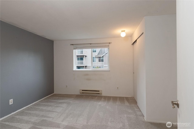 9817 132nd Street Ct E Unit B, Puyallup, WA 98373 - unfurnished room featuring a baseboard heating unit and carpet