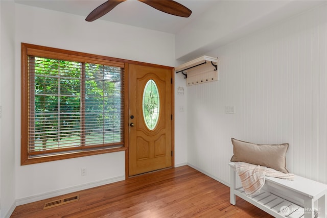 foyer with plenty of natural light, a ceiling fan, light wood-style flooring, and baseboards