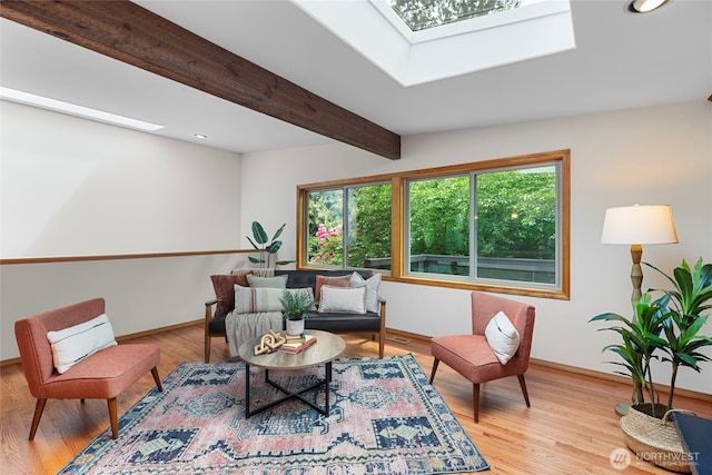 sitting room featuring a skylight, baseboards, wood finished floors, recessed lighting, and beam ceiling