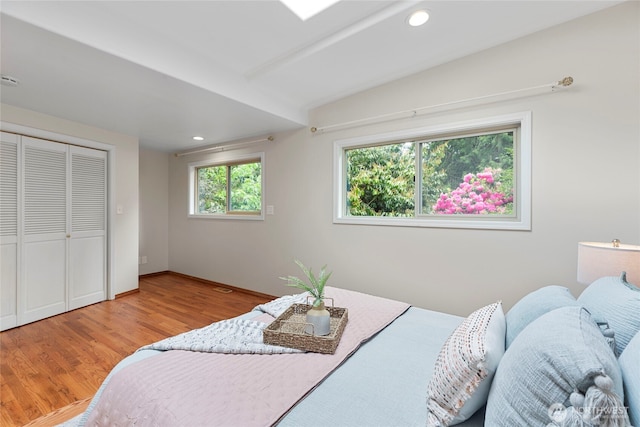 bedroom with light wood finished floors, recessed lighting, and a closet