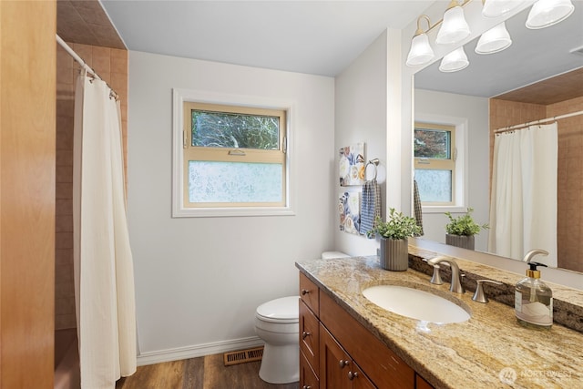 bathroom featuring wood finished floors, vanity, toilet, baseboards, and a shower with shower curtain