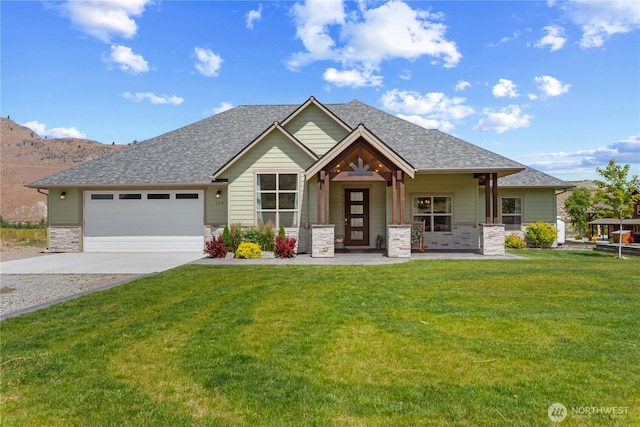 179 N Shore Dr, Orondo, WA 98843 - craftsman house with concrete driveway, a front lawn, stone siding, a garage, and a shingled roof