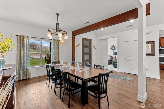 179 N Shore Dr, Orondo, WA 98843 - dining space with a chandelier, light wood-style flooring, beam ceiling, and baseboards