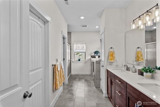 179 N Shore Dr, Orondo, WA 98843 - bathroom with an enclosed shower, washing machine and clothes dryer, double vanity, recessed lighting, and tile patterned floors