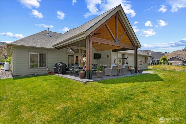 179 N Shore Dr, Orondo, WA 98843 - back of property featuring a patio, roof with shingles, and a lawn
