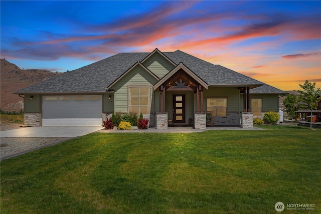 179 N Shore Dr, Orondo, WA 98843 - view of front of property with driveway, a front yard, an attached garage, and a shingled roof
