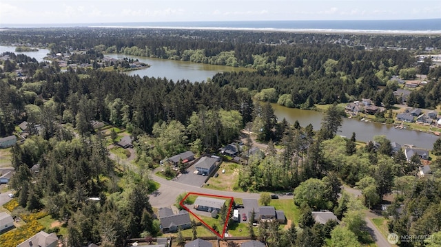 114 Mark Ct SE, Ocean Shores, WA 98569 - view of property location featuring a heavily wooded area, property parcel outlined, a large body of water, and nearby suburban area