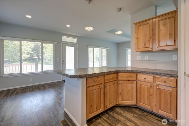 114 Mark Ct SE, Ocean Shores, WA 98569 - kitchen featuring dark countertops, dark wood finished floors, a peninsula, baseboards, and recessed lighting