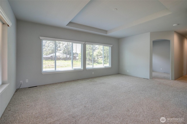 114 Mark Ct SE, Ocean Shores, WA 98569 - empty room with healthy amount of natural light, carpet, and a raised ceiling