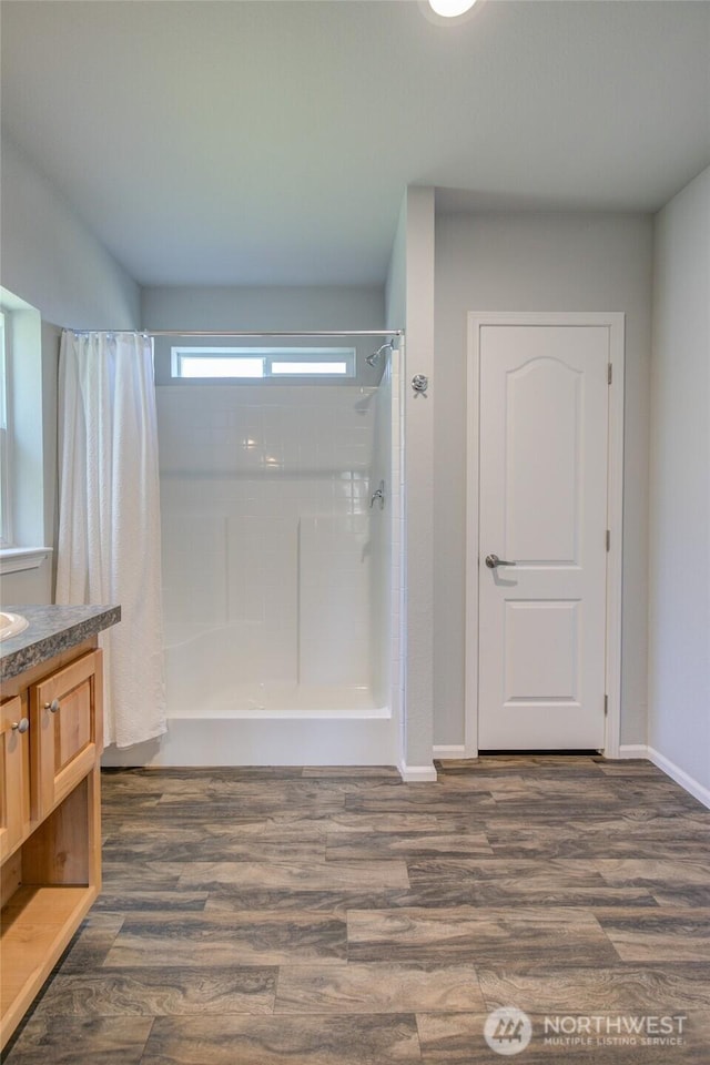 114 Mark Ct SE, Ocean Shores, WA 98569 - bathroom featuring a shower with curtain, vanity, wood finished floors, and baseboards