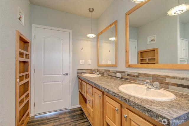 114 Mark Ct SE, Ocean Shores, WA 98569 - bathroom with wood finished floors, double vanity, and decorative backsplash
