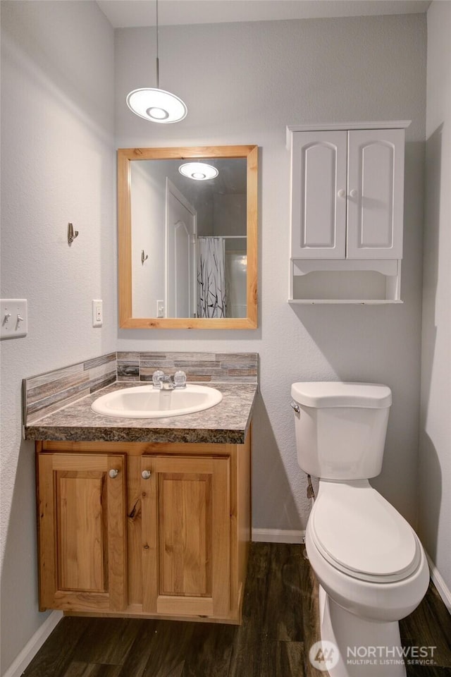 114 Mark Ct SE, Ocean Shores, WA 98569 - full bath with wood finished floors, baseboards, vanity, and toilet