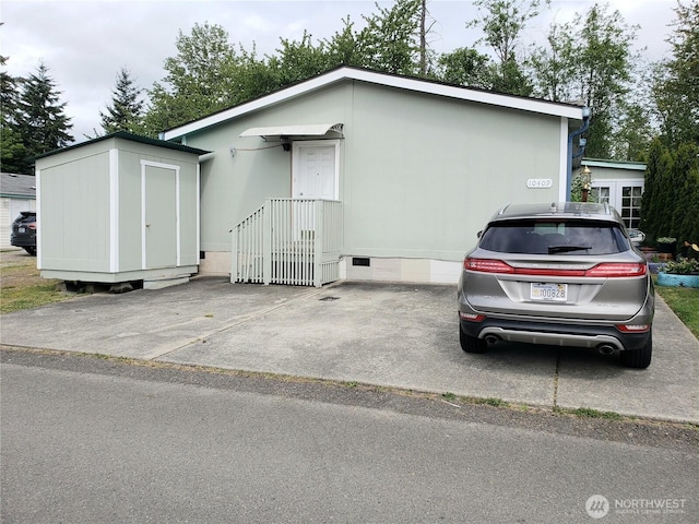 10409 137th St E Unit 9, Puyallup, WA 98374 - view of front facade featuring an outbuilding, a storage shed, and crawl space
