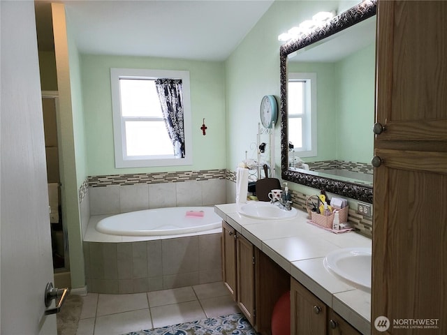 10409 137th St E Unit 9, Puyallup, WA 98374 - bathroom with healthy amount of natural light, a bath, tile patterned floors, and double vanity