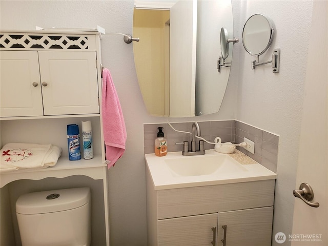 10409 137th St E Unit 9, Puyallup, WA 98374 - bathroom featuring vanity, decorative backsplash, and toilet