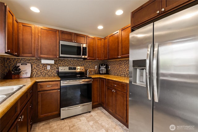 5510 83rd Ave W, University Place, WA 98467 - kitchen featuring stainless steel appliances, backsplash, recessed lighting, and a sink