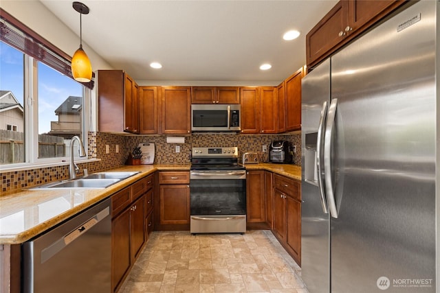 5510 83rd Ave W, University Place, WA 98467 - kitchen featuring stainless steel appliances, a sink, backsplash, brown cabinets, and recessed lighting