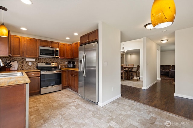 5510 83rd Ave W, University Place, WA 98467 - kitchen featuring stainless steel appliances, a sink, backsplash, baseboards, and recessed lighting