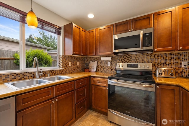 5510 83rd Ave W, University Place, WA 98467 - kitchen featuring appliances with stainless steel finishes, a sink, light countertops, tasteful backsplash, and recessed lighting