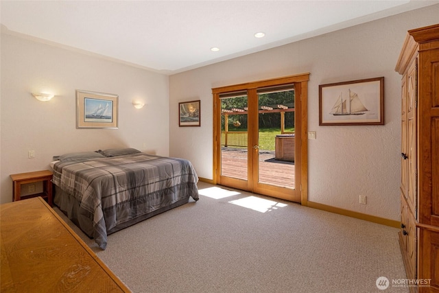 591 Wold Rd, Friday Harbor, WA 98250 - bedroom with baseboards, carpet flooring, access to exterior, a textured wall, and french doors