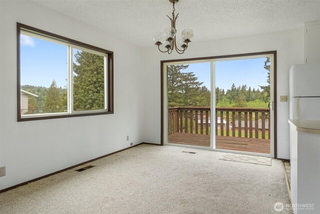 107 Mayfield Cir, Mossyrock, WA 98564 - carpeted empty room featuring plenty of natural light, a chandelier, a textured ceiling, and baseboards