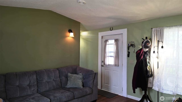 1900 Broadway Ave Unit 2, Hoquiam, WA 98550 - living room featuring dark wood-style flooring, vaulted ceiling, and baseboards