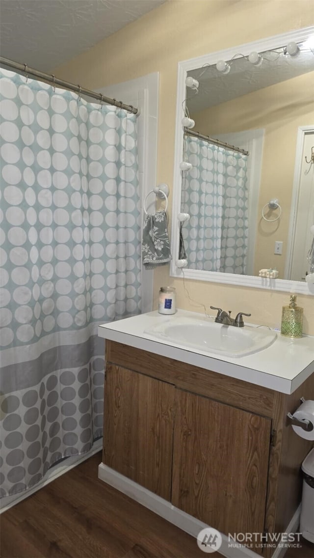 1900 Broadway Ave Unit 2, Hoquiam, WA 98550 - bathroom with wood finished floors, vanity, and curtained shower