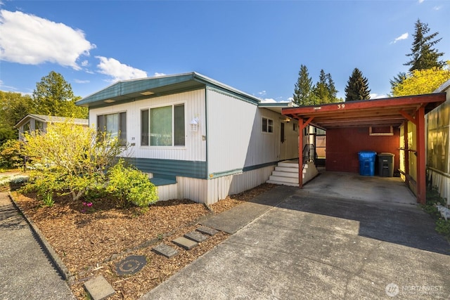 view of front of house featuring concrete driveway and an attached carport