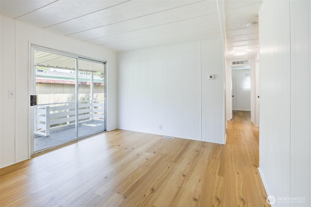 empty room featuring light wood-style flooring and a smoke detector