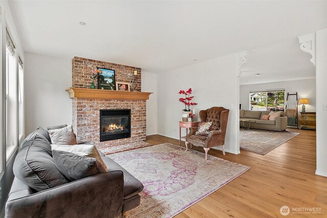 living area with wood finished floors and a fireplace