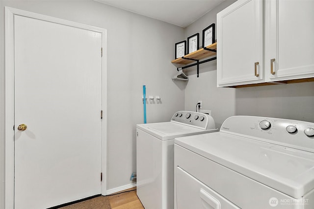 laundry area with independent washer and dryer, cabinet space, and light wood-style floors