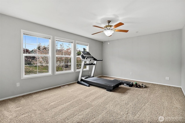 workout room with carpet floors, ceiling fan, and baseboards