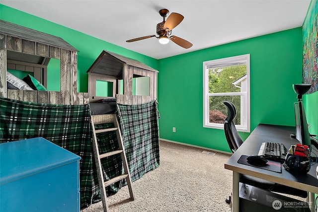 bedroom with carpet floors and an office area
