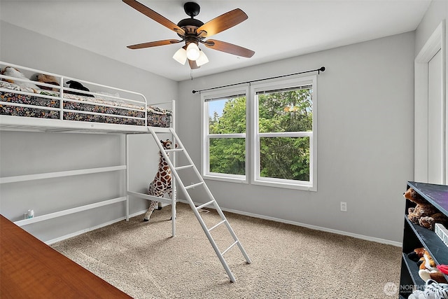 unfurnished bedroom featuring baseboards, a ceiling fan, and carpet flooring