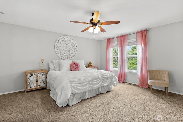 carpeted bedroom with a ceiling fan and baseboards