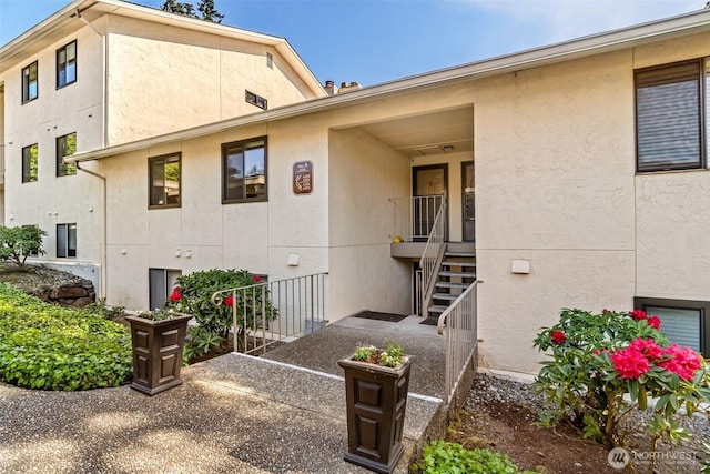 rear view of house with stucco siding